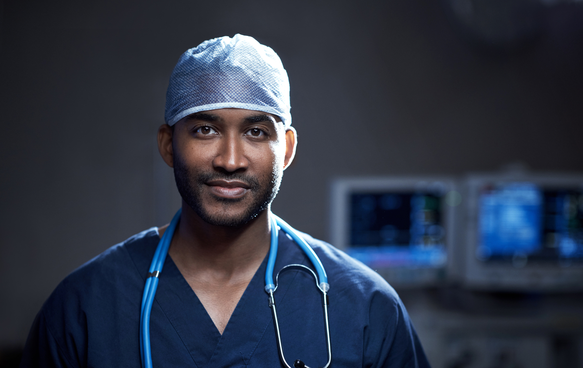 592647638 Portrait of a confident young surgeon standing in an operating room